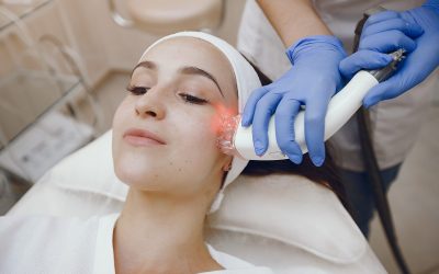 Cosmetologist use laser. Woman with cosmetologist. Lady in a beauty studio.